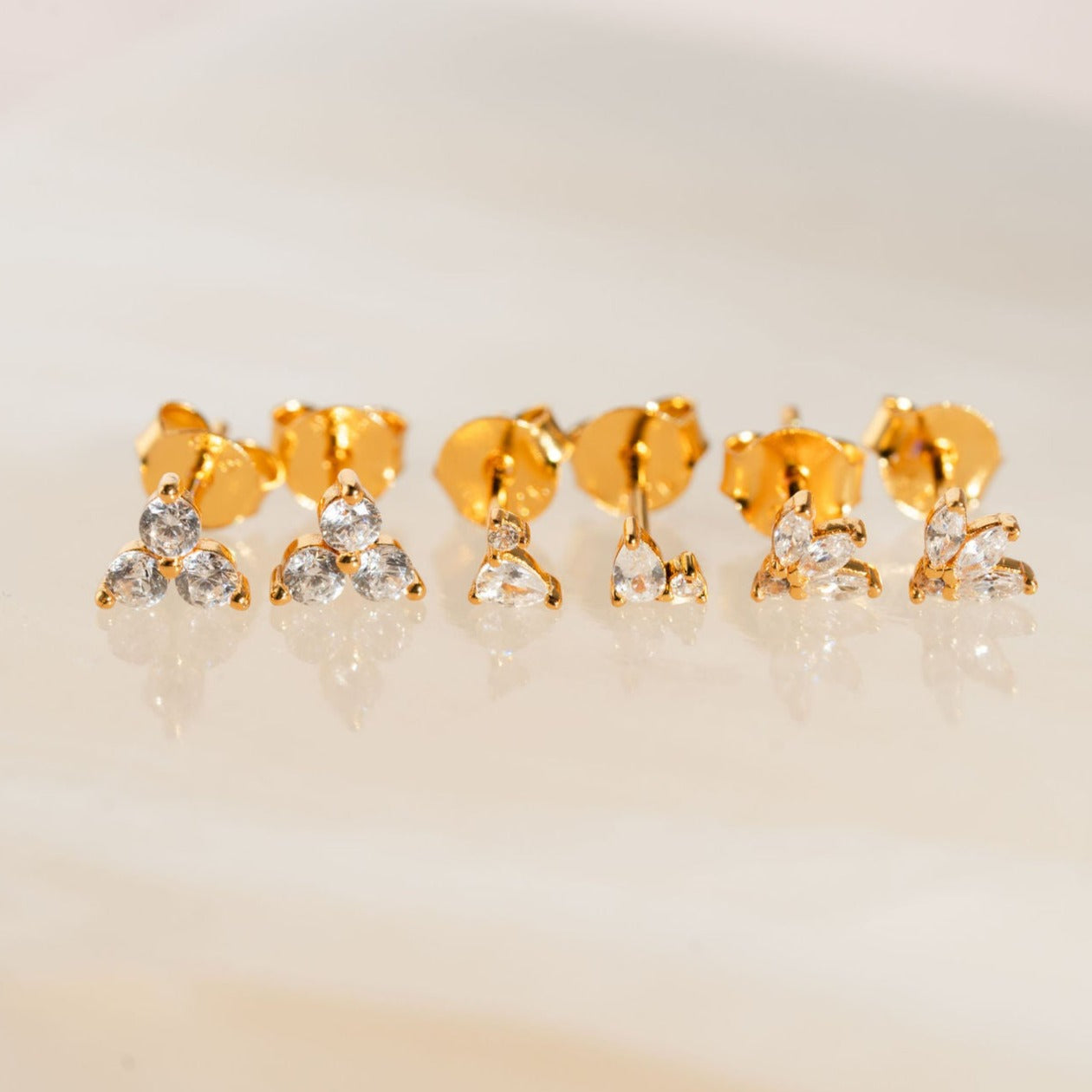 Three pairs of sleek 18k gold vermeil and diamond earrings from Pink Cove.