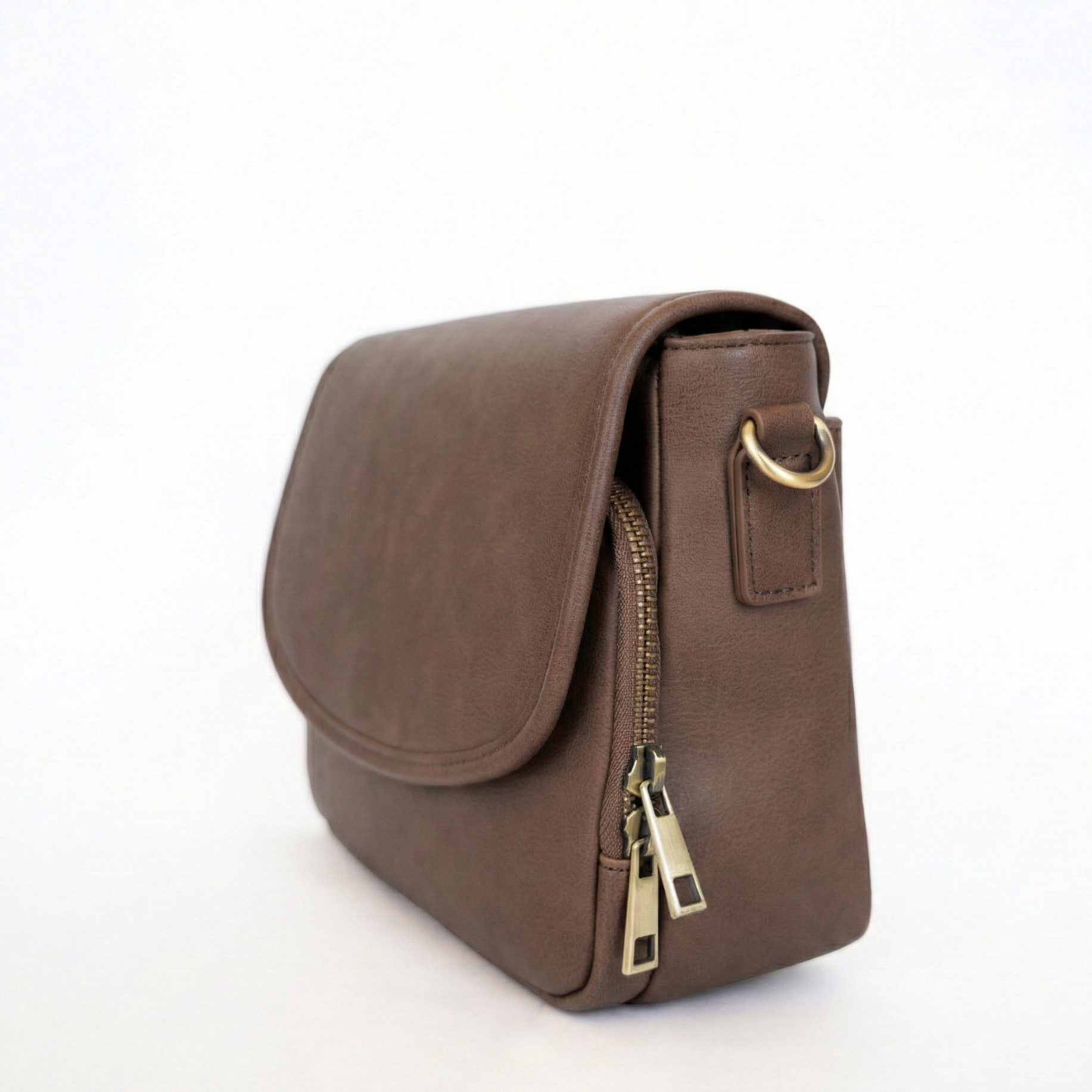 Brown leather bag with brass zipper on a white background